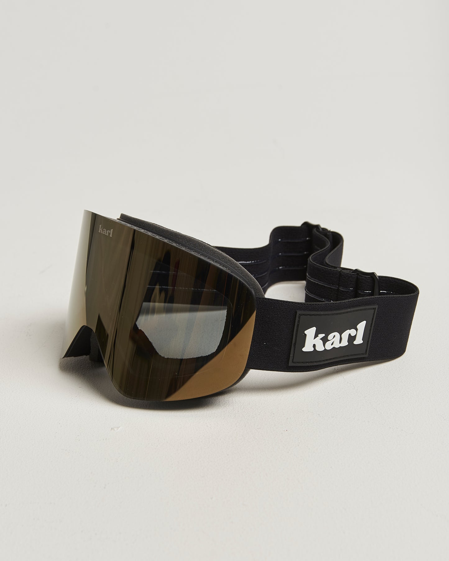 Black ski goggles with bronze lens side view