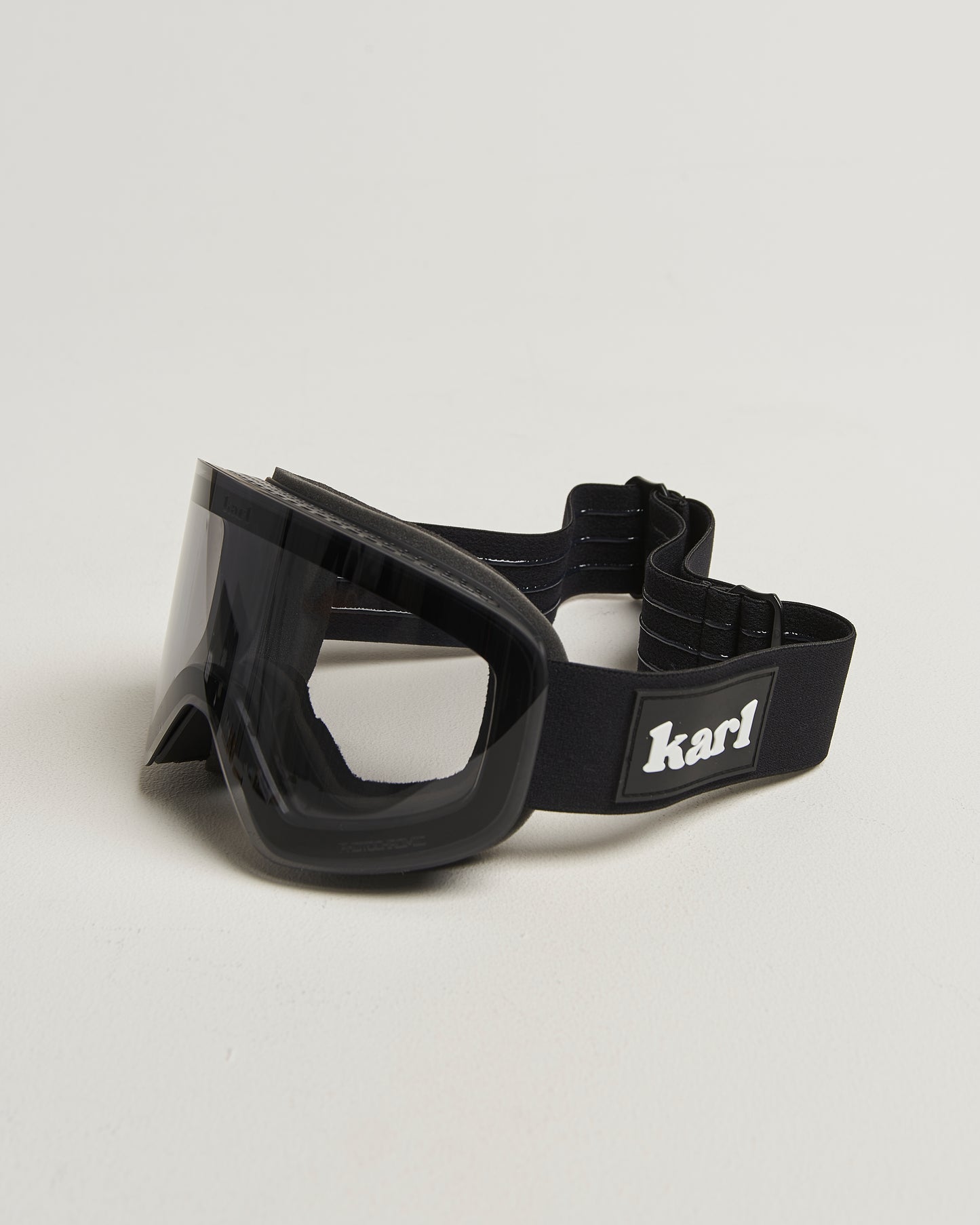 Black ski goggles with photochromic lens side view