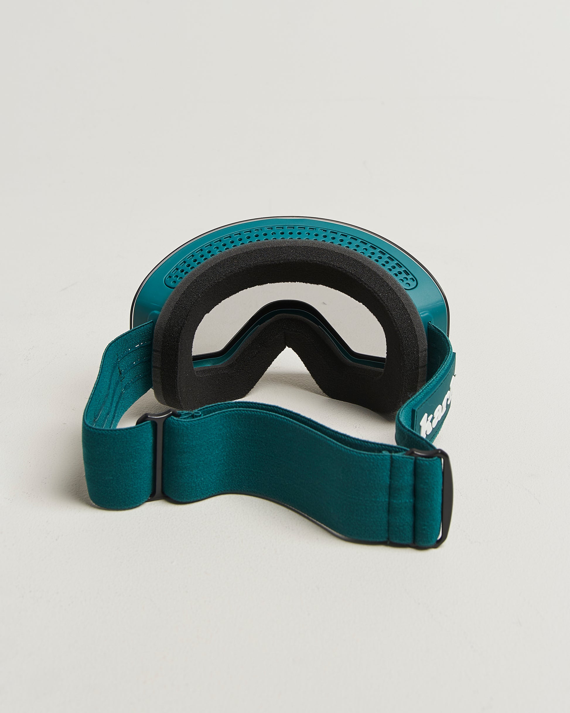 Green ski goggles with photochromic lens from behind