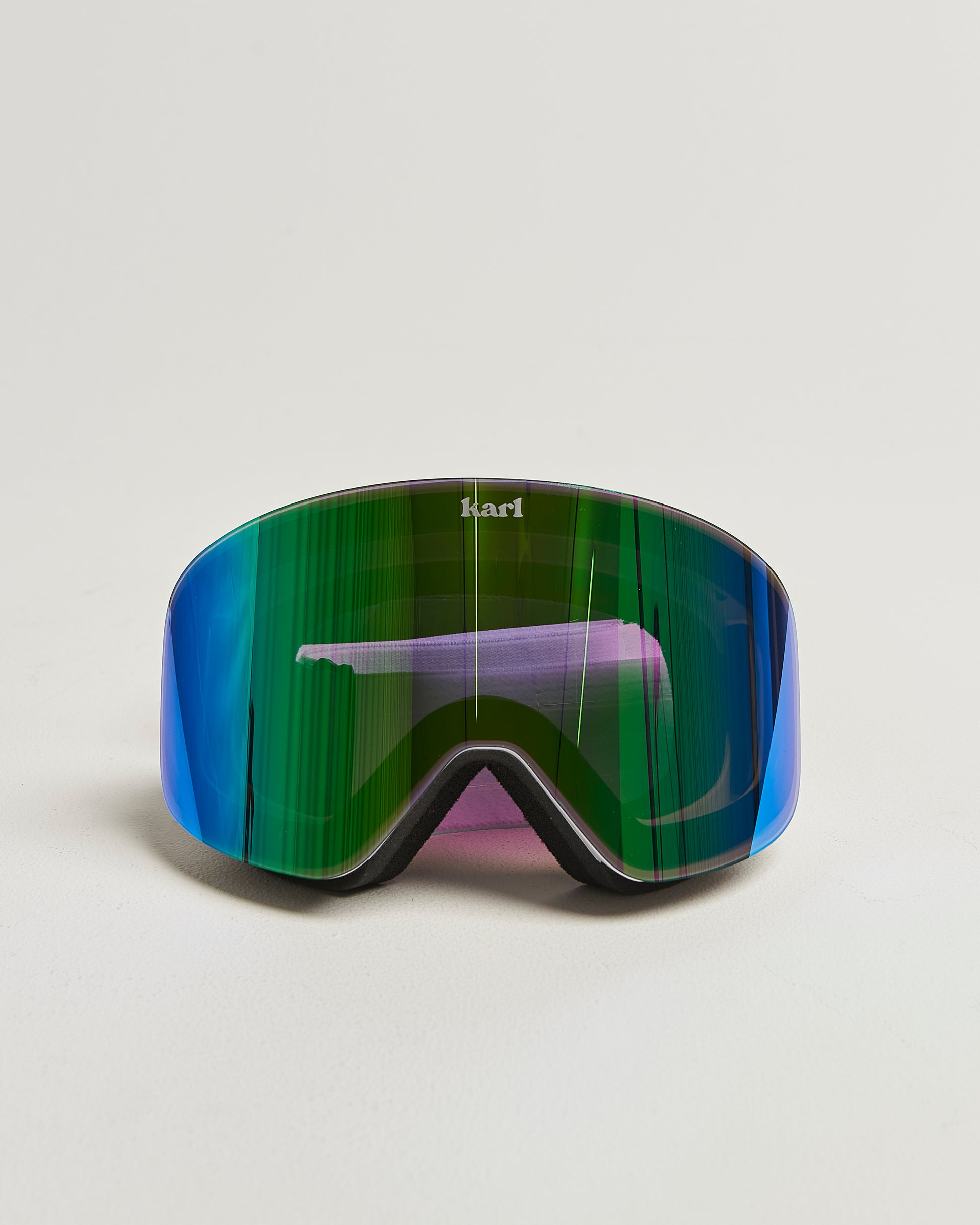 White ski goggles with green lens front view