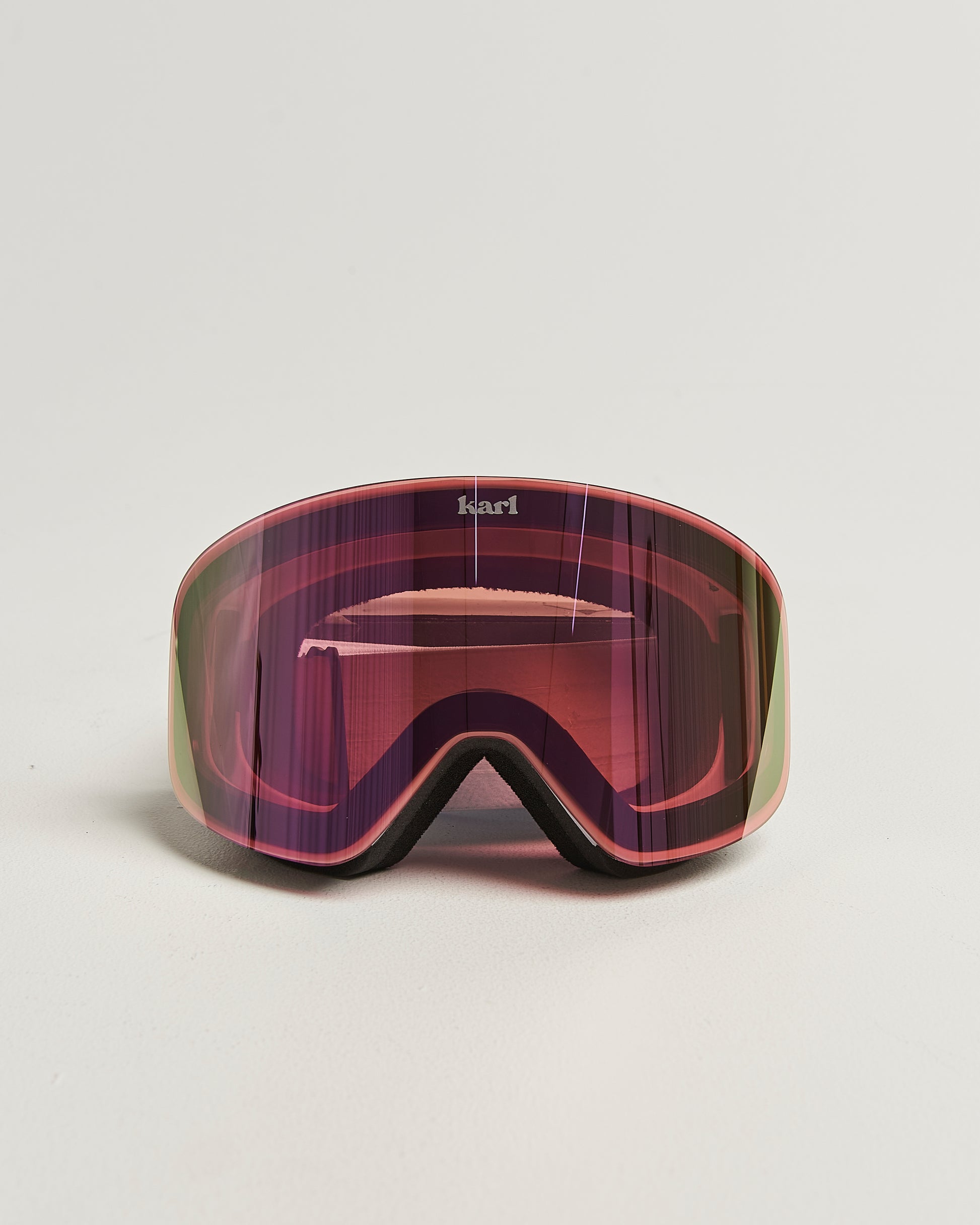 White ski goggles with pink lens front view
