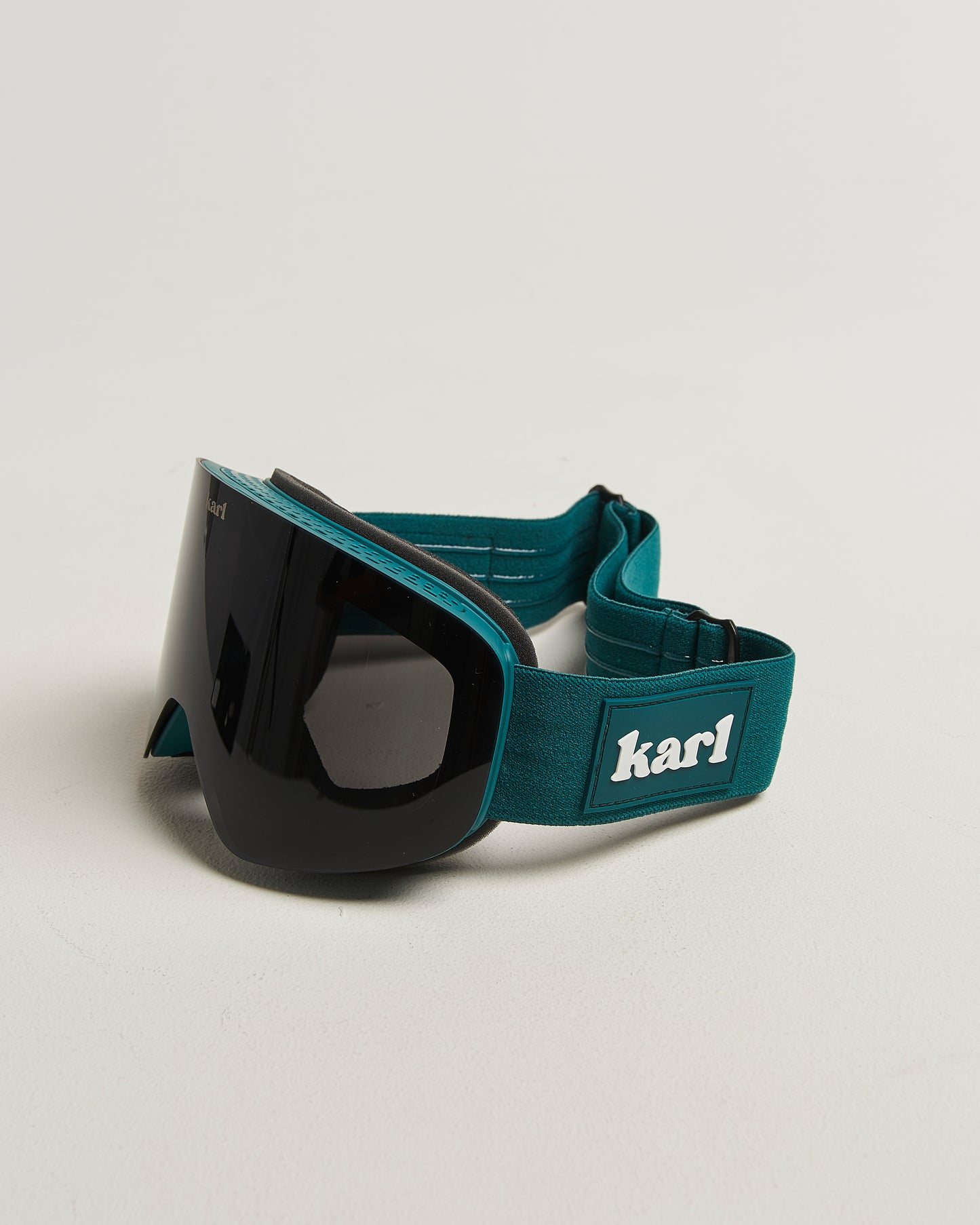 Green ski goggles with black lens side view