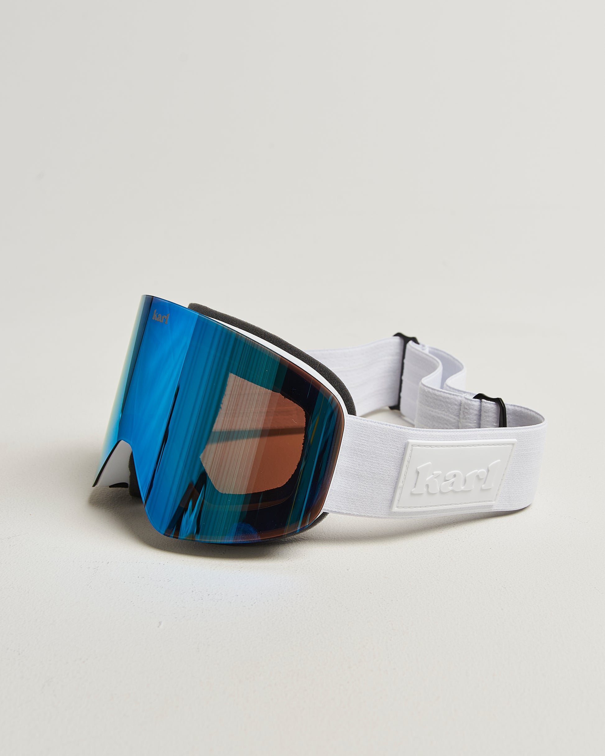 White ski goggles with blue lens side view