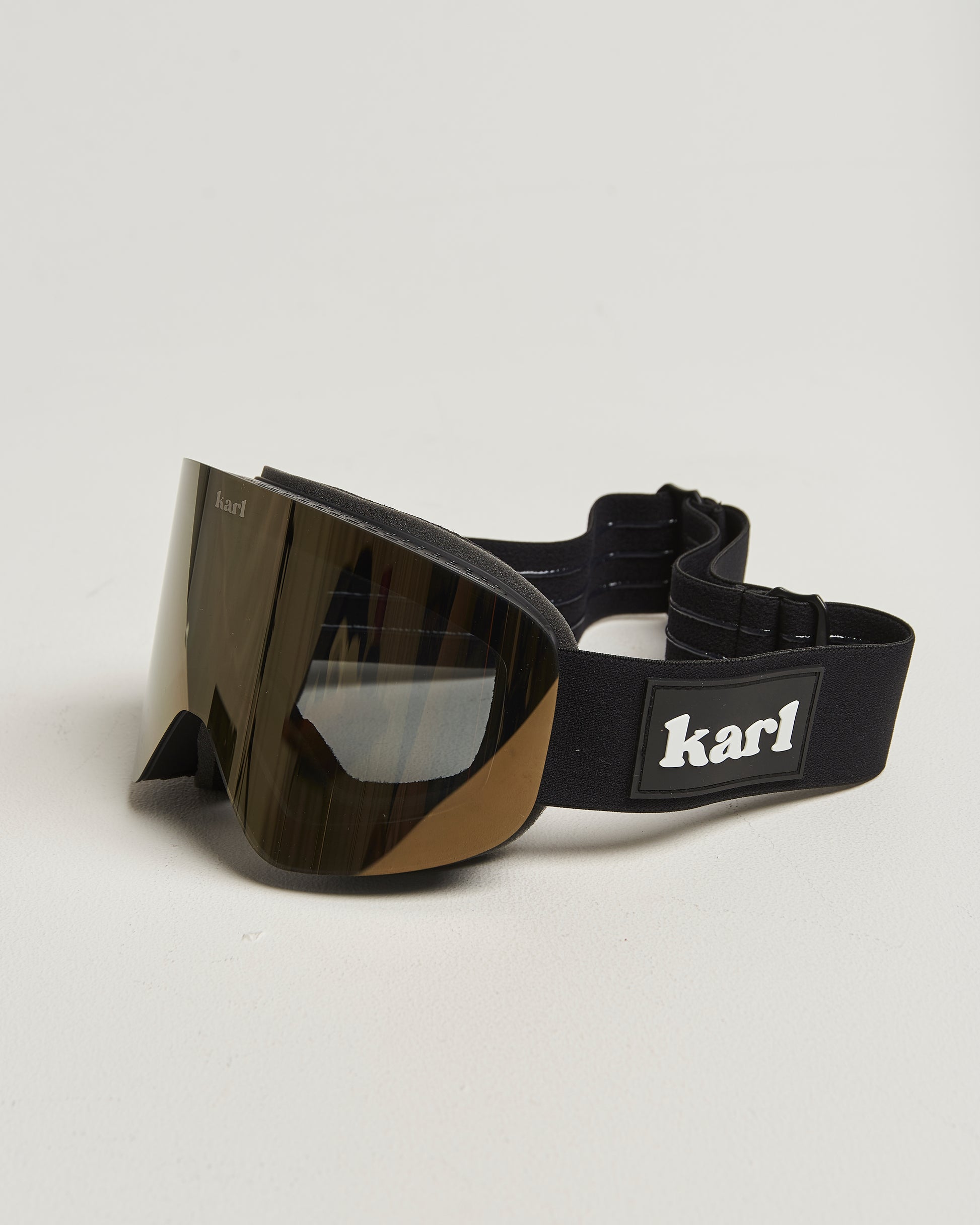 Black ski goggles with bronze lens side view