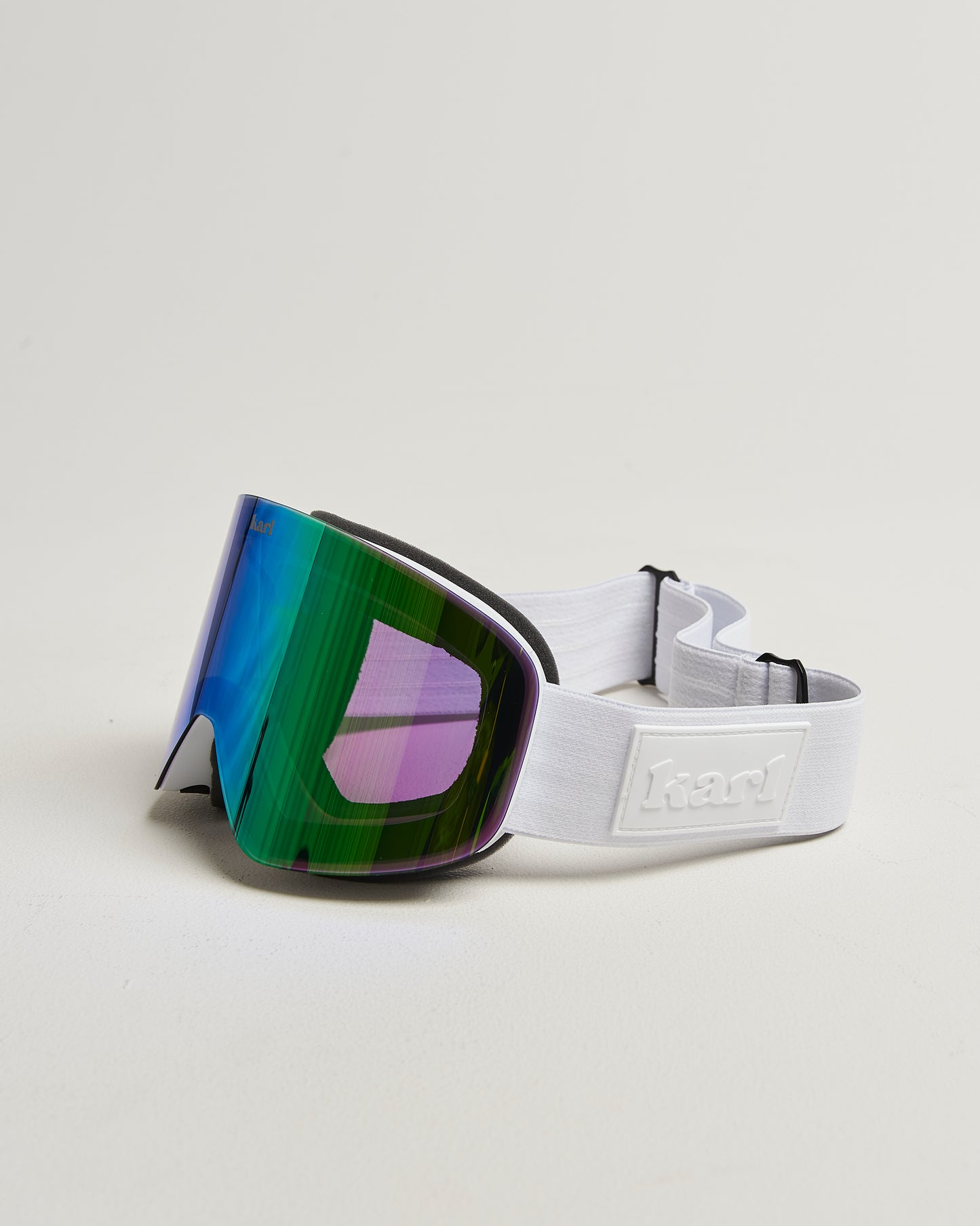 White ski goggles with green lens side view